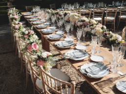 Luxury wedding table setting in pink and cream garden party style with lots of flowers