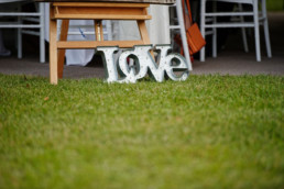 Love sign on lawns at wedding of Bobby and James at Chateau La Gauterie France