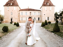 Bride and groom kissing after wedding in front of Grand rustic Gascon Chateau venue in the Gers SW France