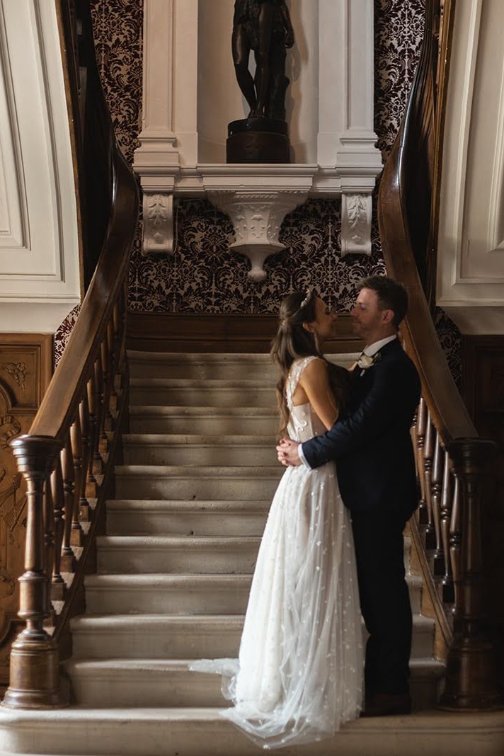 Bride and groom standing on main staircase at this Autumn Wedding at Chateau de la Valouze