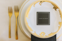 Ornate_white_and_gold_wedding_place_wetting_with_black_napkin_and_place_card