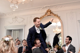 Groom_hoisted_onto_friends_shoulders_at_Wedding_in_France_as_COVID_Rules_Lifted